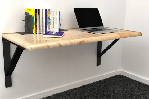 Solidne mocowanie blatu do ściany, na którym stoi laptop i książki. Idealne do małych przestrzeni.