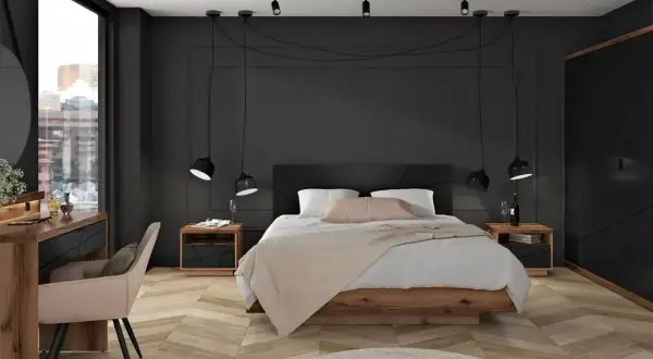Mała sypialnia w stylu industrialnym. Drewniana podłoga, czarne ściany i meble, wiszące lampy.
