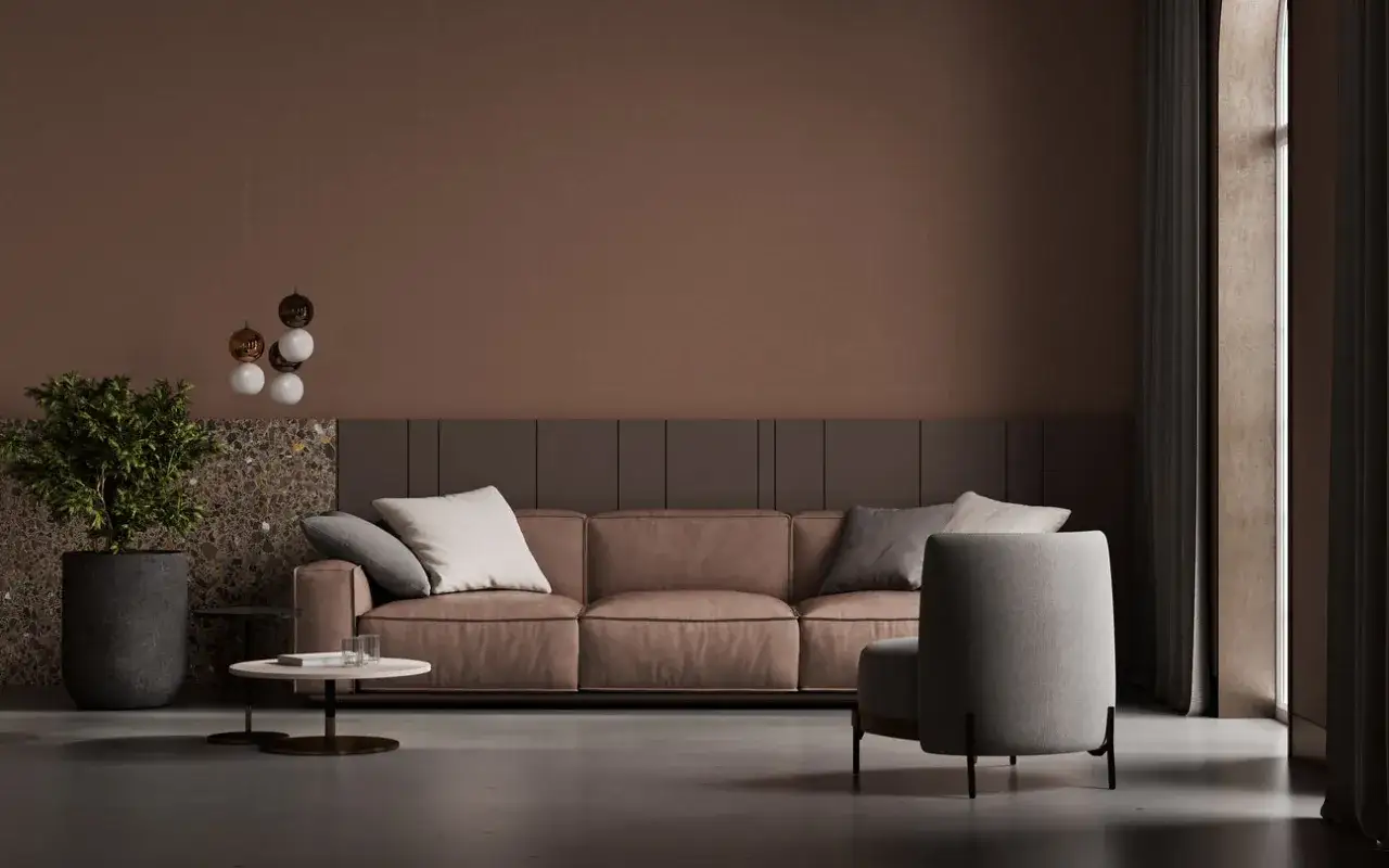 Elegancka brązowa kanapa w salonie aranżacje. Miękkie poduszki, nowoczesne oświetlenie i stylowe dodatki tworzą przytulną atmosferę.