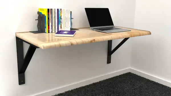 Solidne mocowanie blatu do ściany, na którym stoi laptop i książki. Idealne do małych przestrzeni.